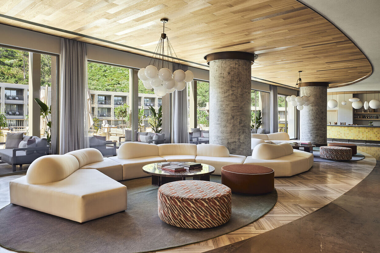 Lobby at Hyde Bodrum with long beige sofa and wide windows
