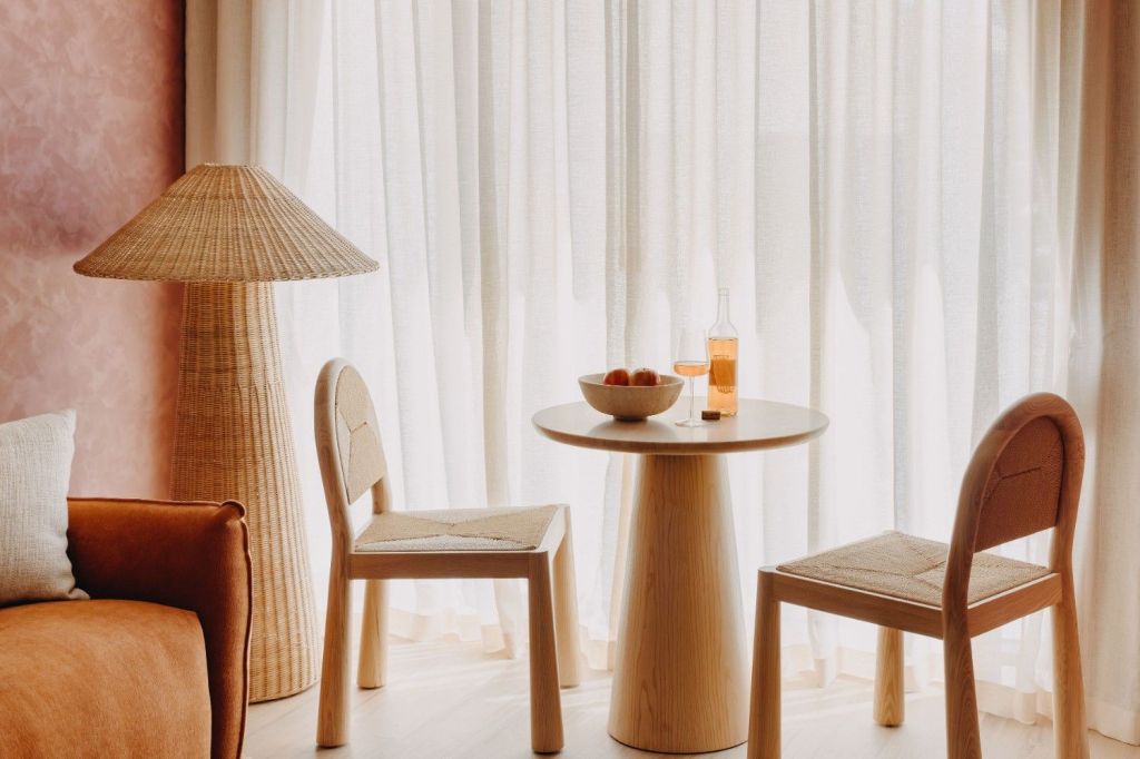 Warm seating area with round table, and chair.