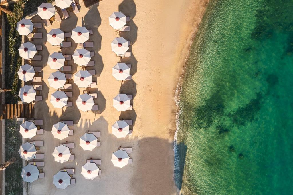 drone picture of the beach at Hyde Bodrum with mutliple empty sunbeds and the sea