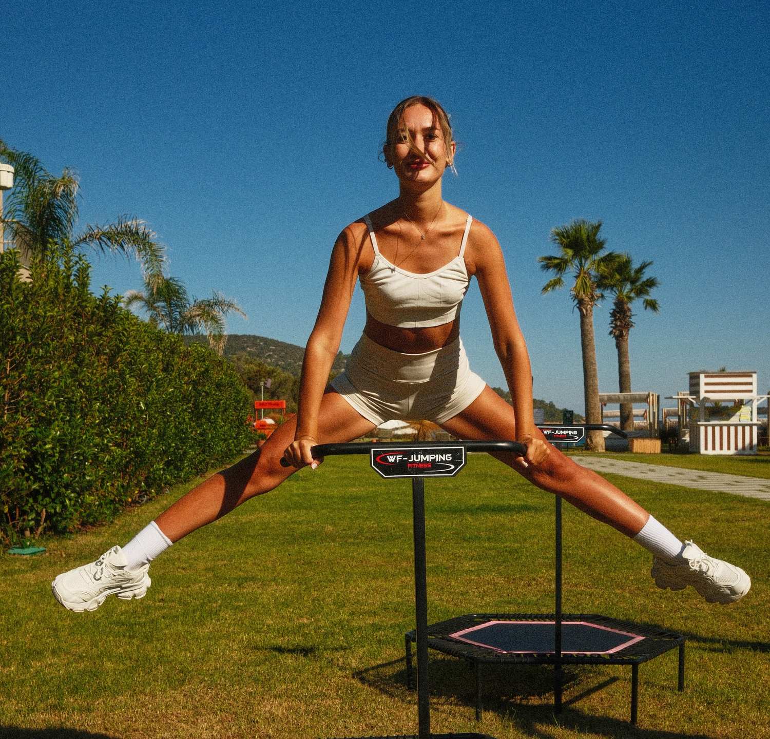 woman jumping on a trampoline outside