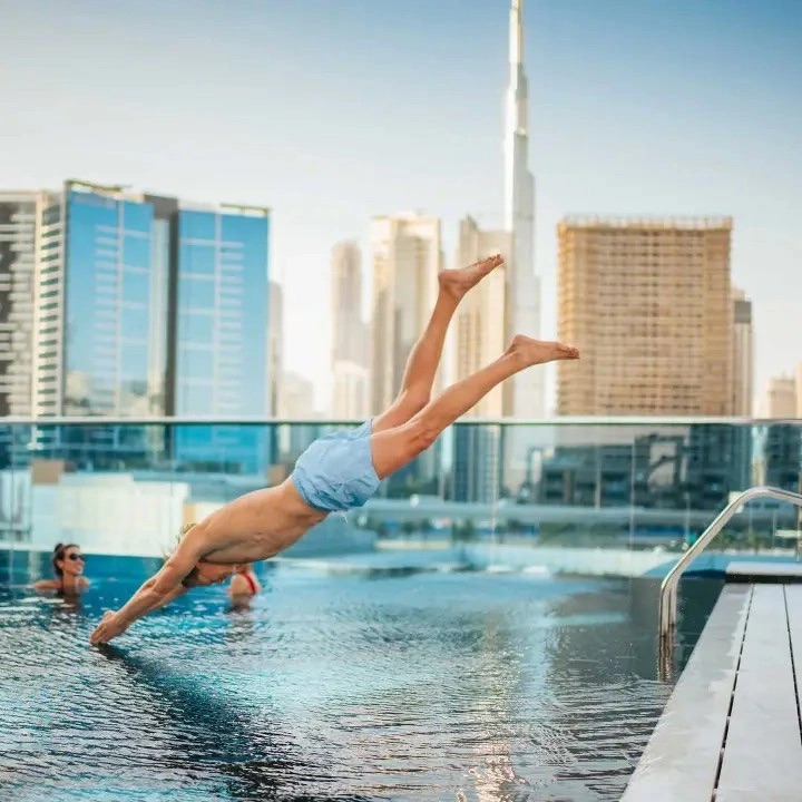 man jumping in pool