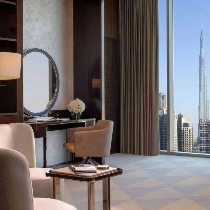 corner of a room with view of dubai in the background and chair sitting in front of a mirror