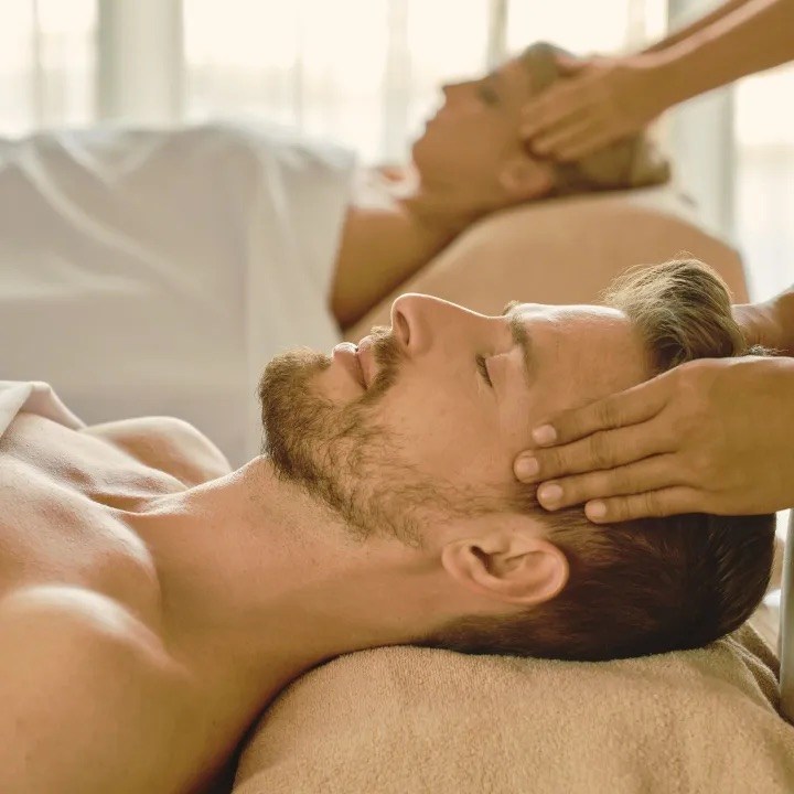 Someone at a spa enjoying a head massage