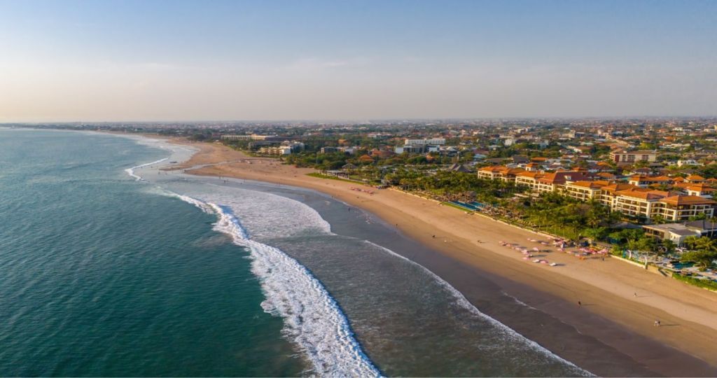 Aerial view of Seminyak beach, with the ocean in the foreground