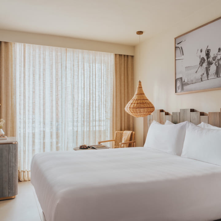 image of bed with white bedding and curtains closed