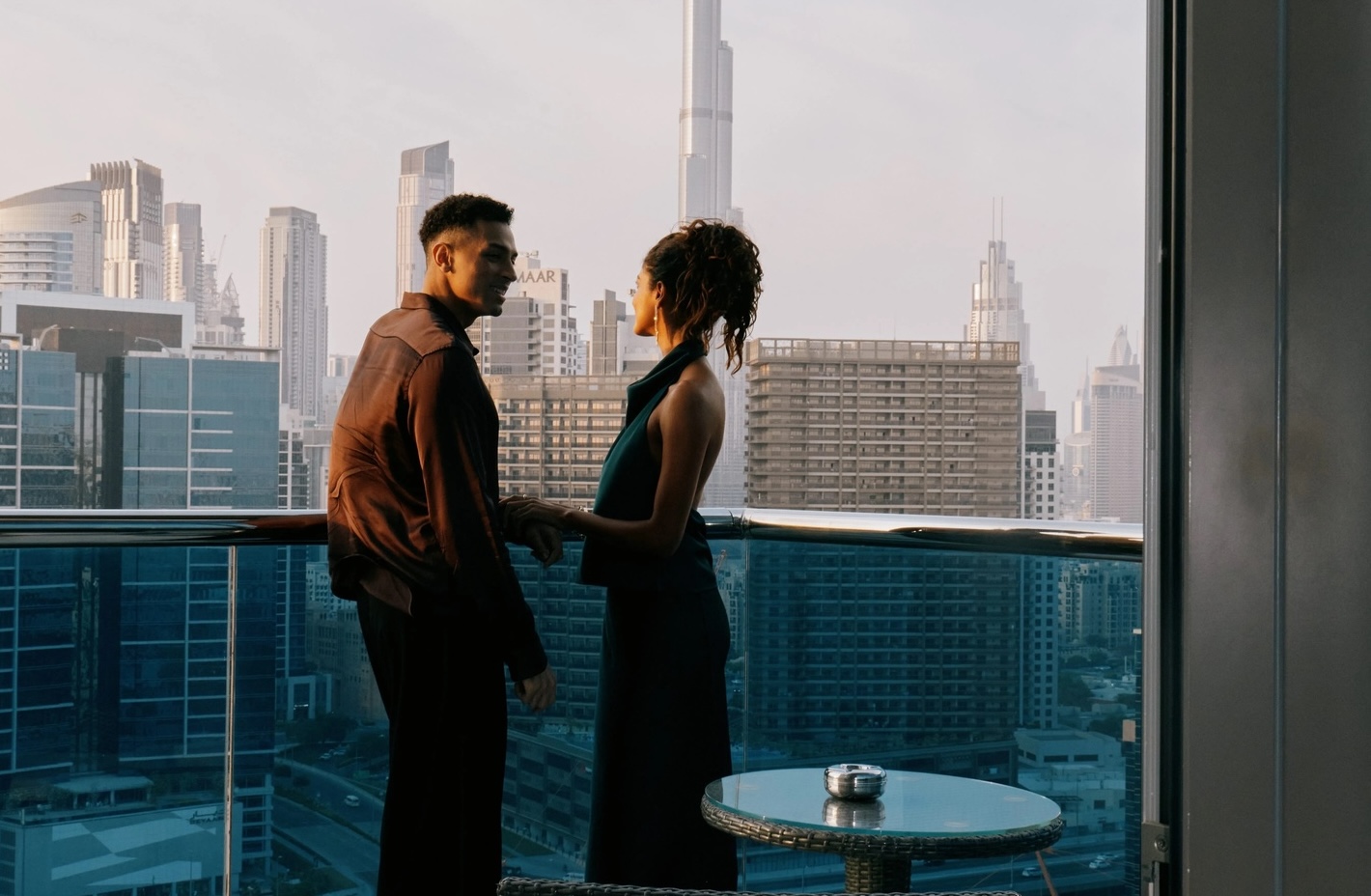 two people on a terrace with multiple buildings in the background