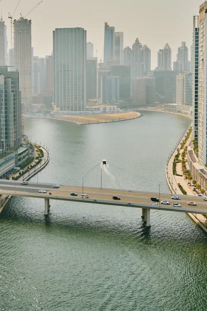 image of a body of water with a bridge going from left to right and a boat in the water