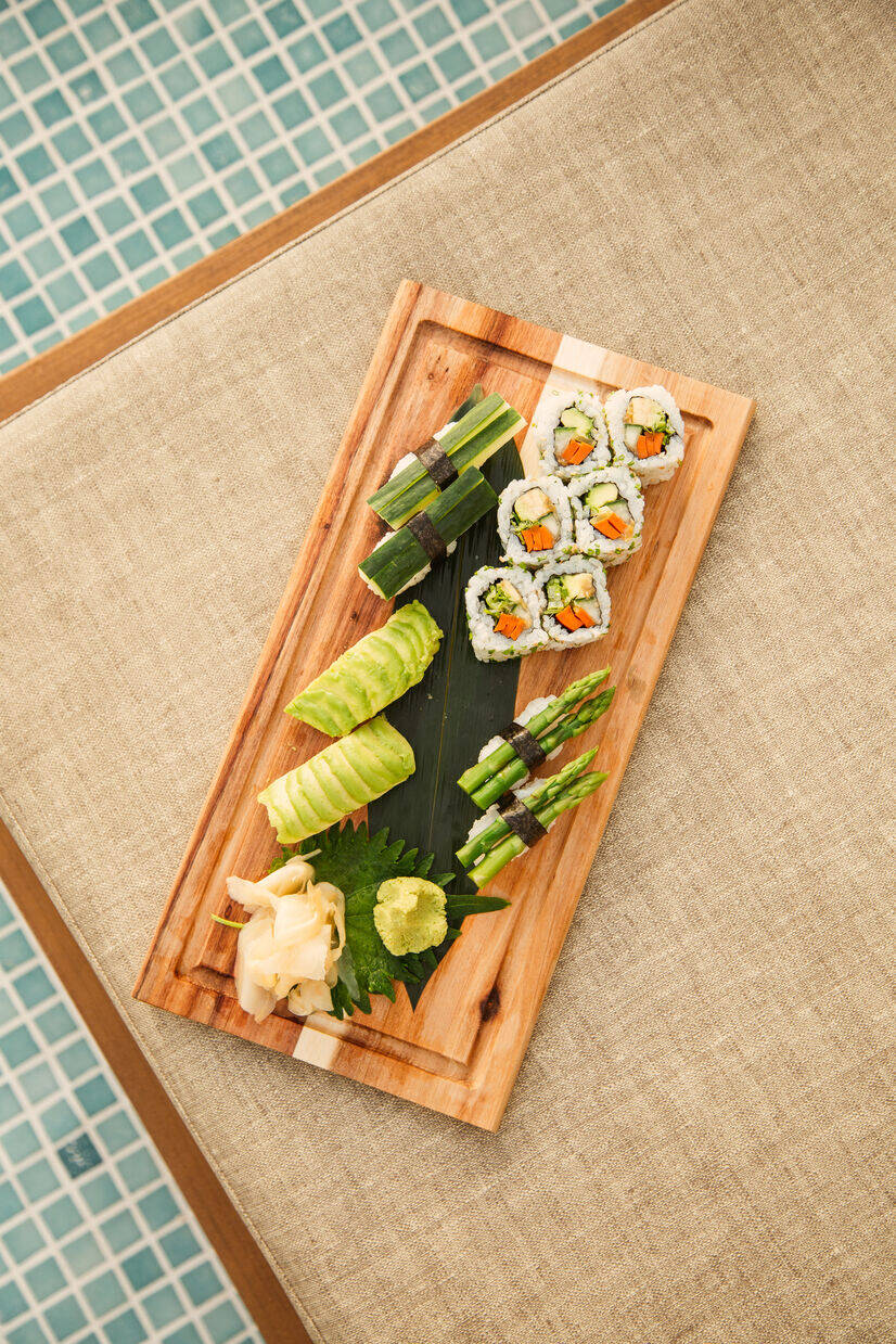 large tray of food with multiple types of sushi on it