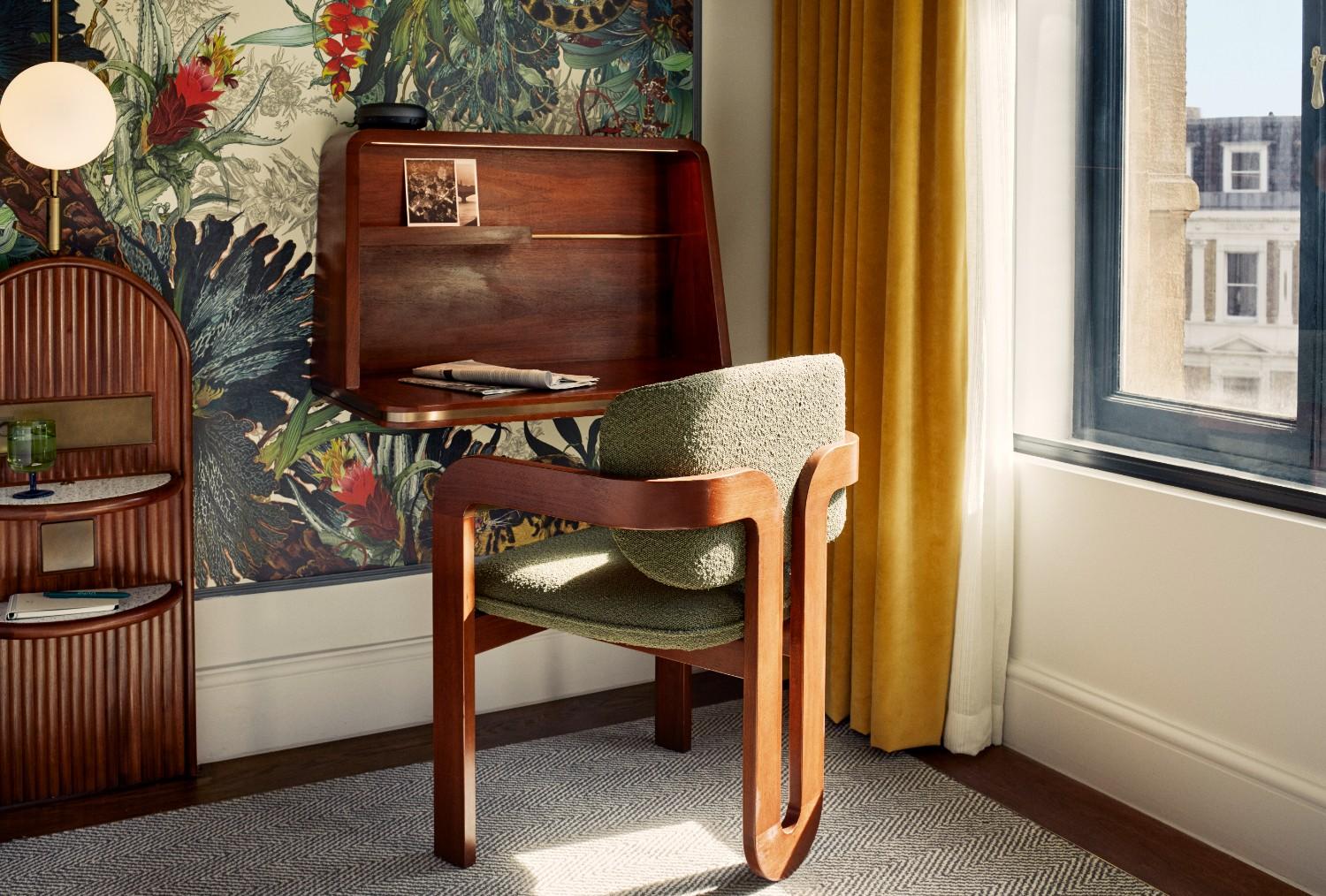 Green desk chair with sunlight coming in through the bedroom window