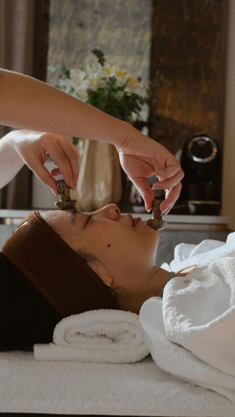 woman attending a treatment with two object being placed by her face