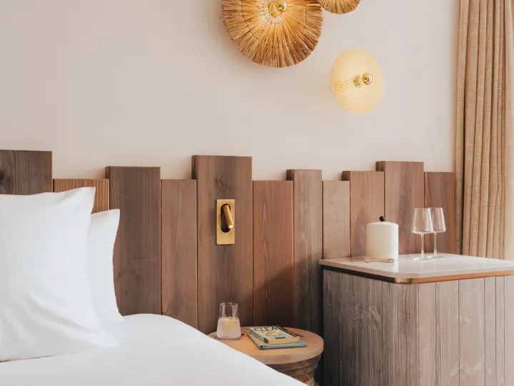 bed with bedside table and coffee station next to it