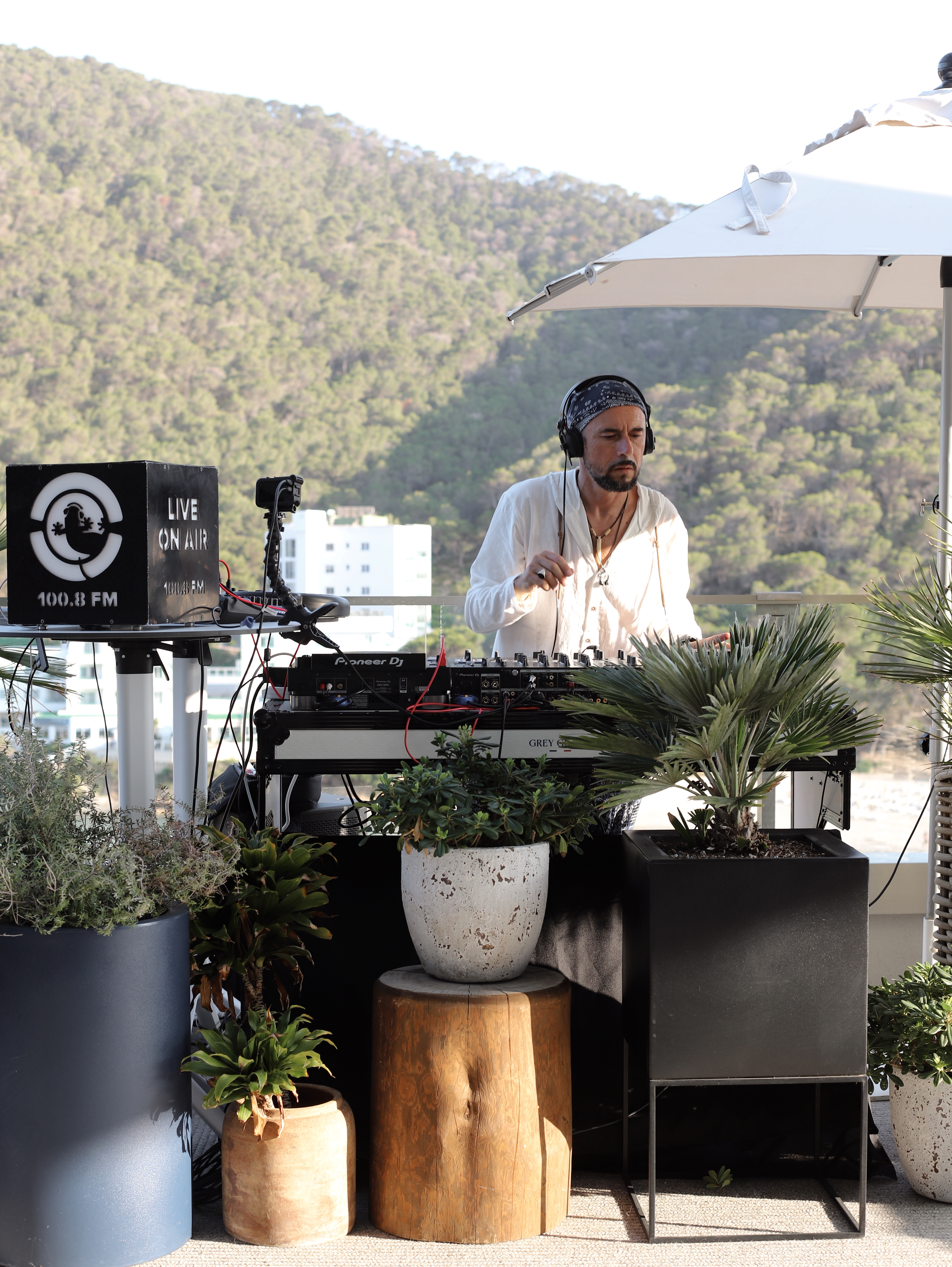 man behind a dj desk outside