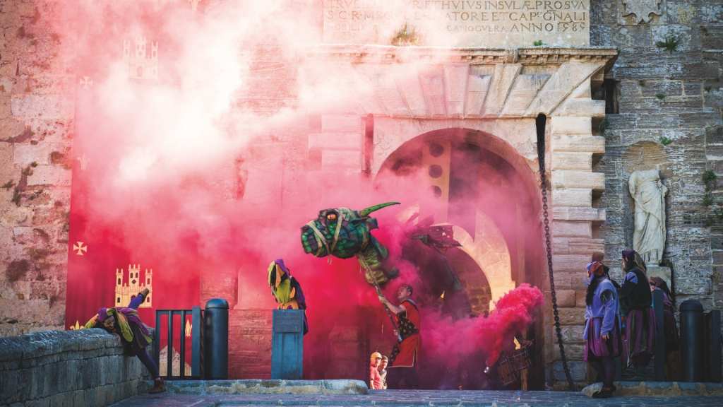image of a festival with a dragon coming out of a well with pink smoke