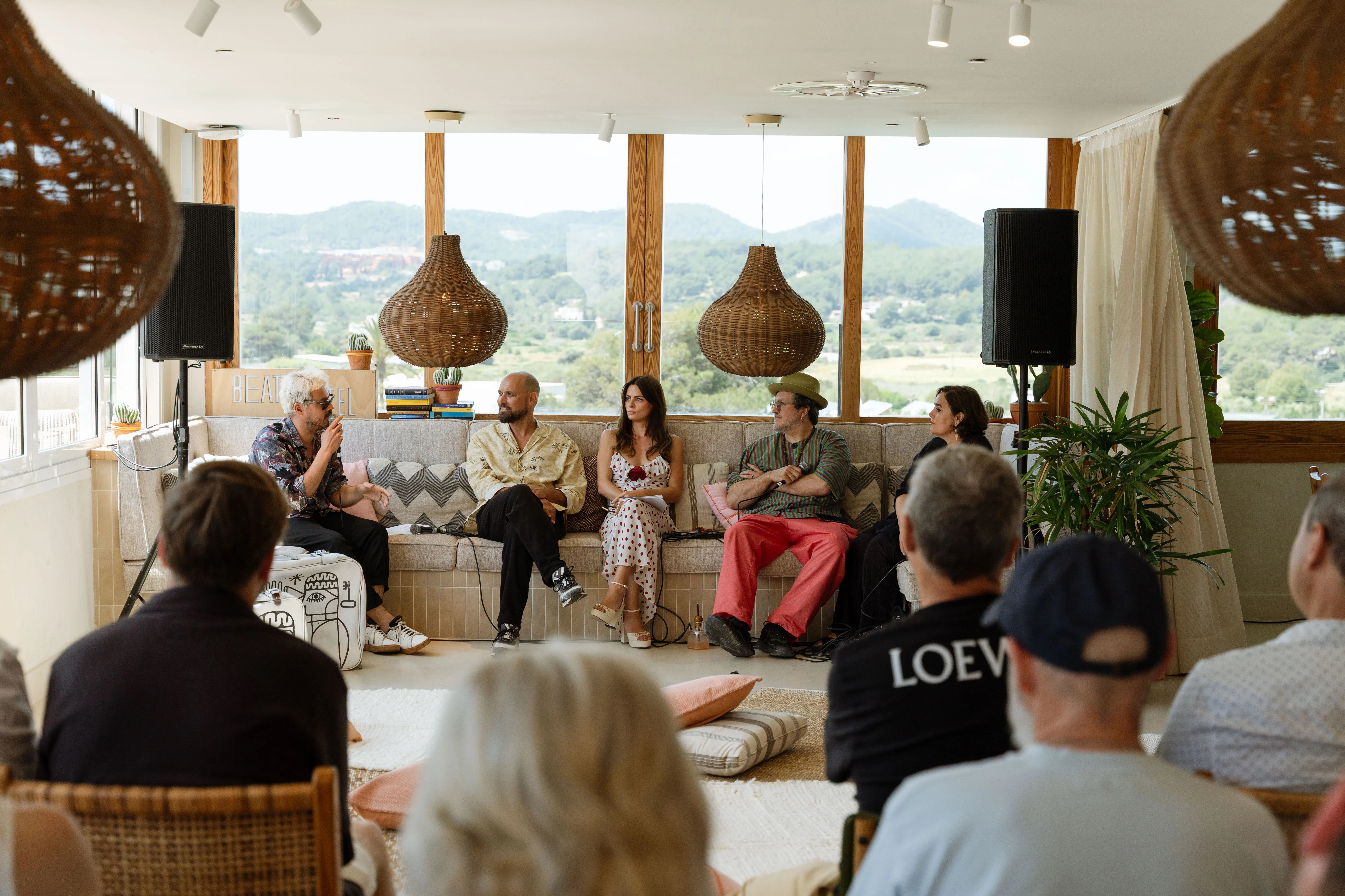 people sitting inside on a couch discussing something together