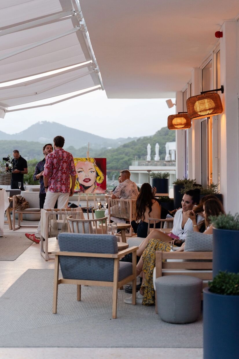 people sitting outside looking at art