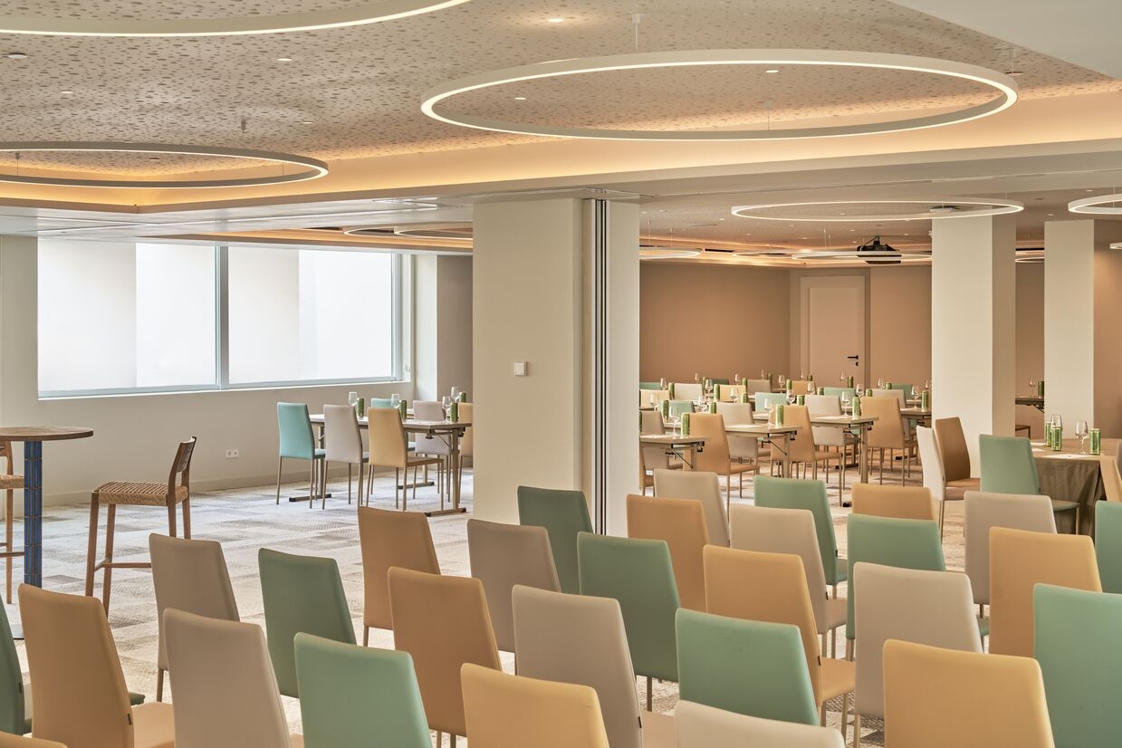 Empty meeting room with colourful chairs lined up next to each other