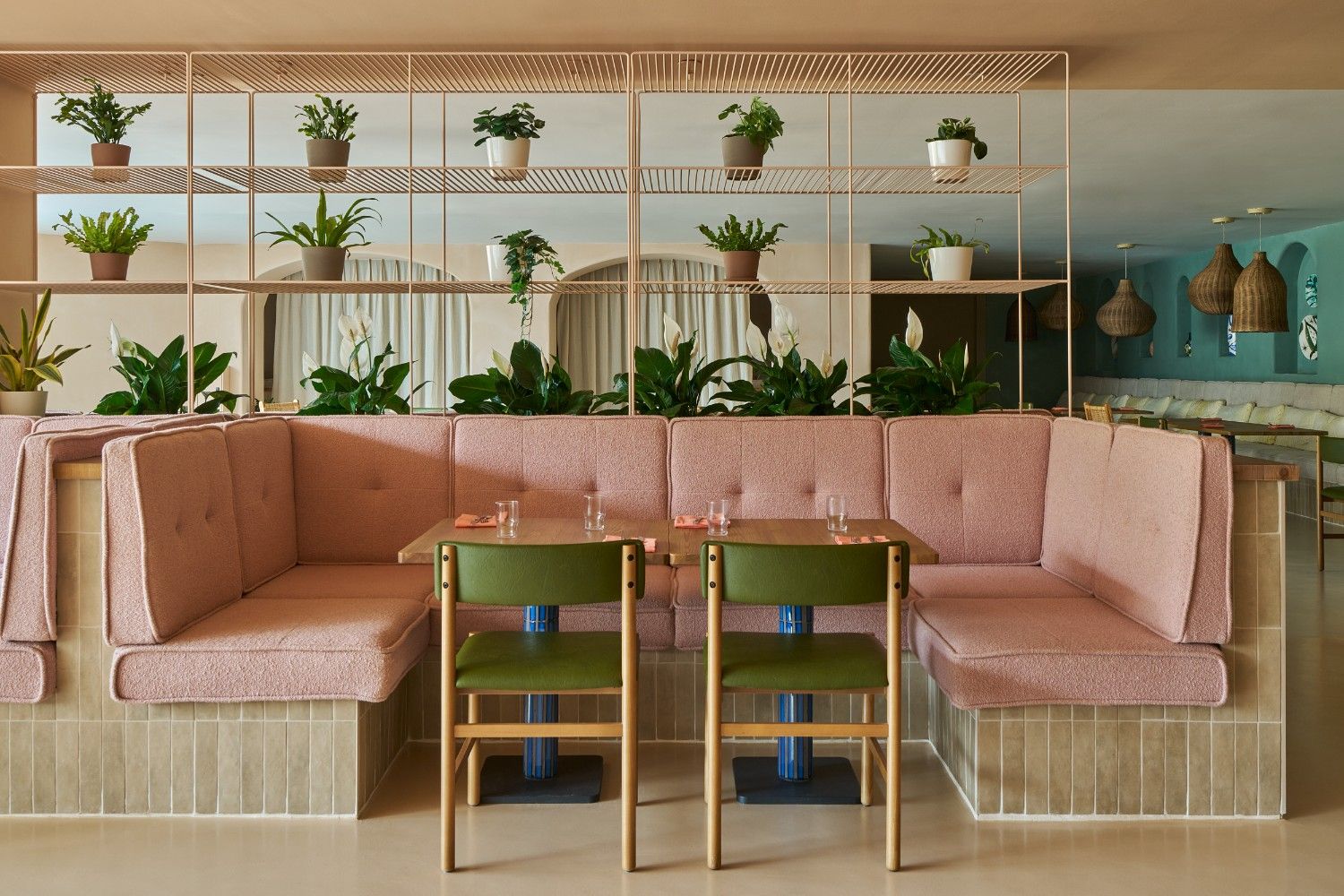 seating area for the Hyde breakfast with a pink couch and green chairs around a table