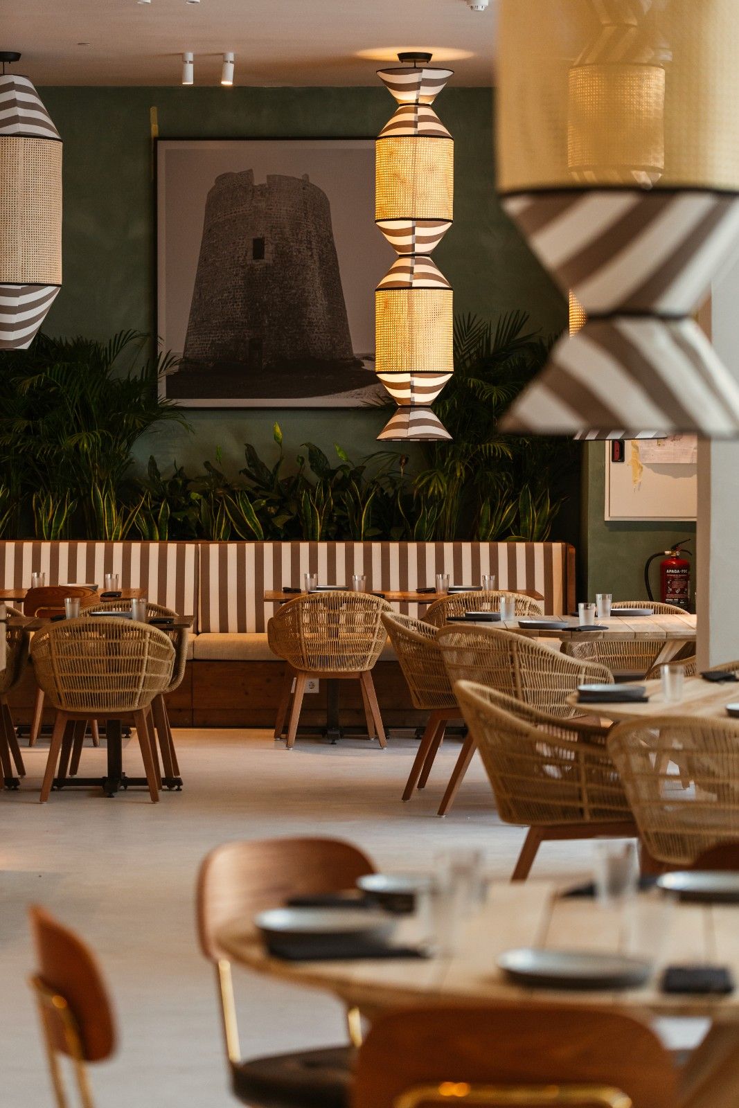 a couple of tables with chairs around them from the restaurant