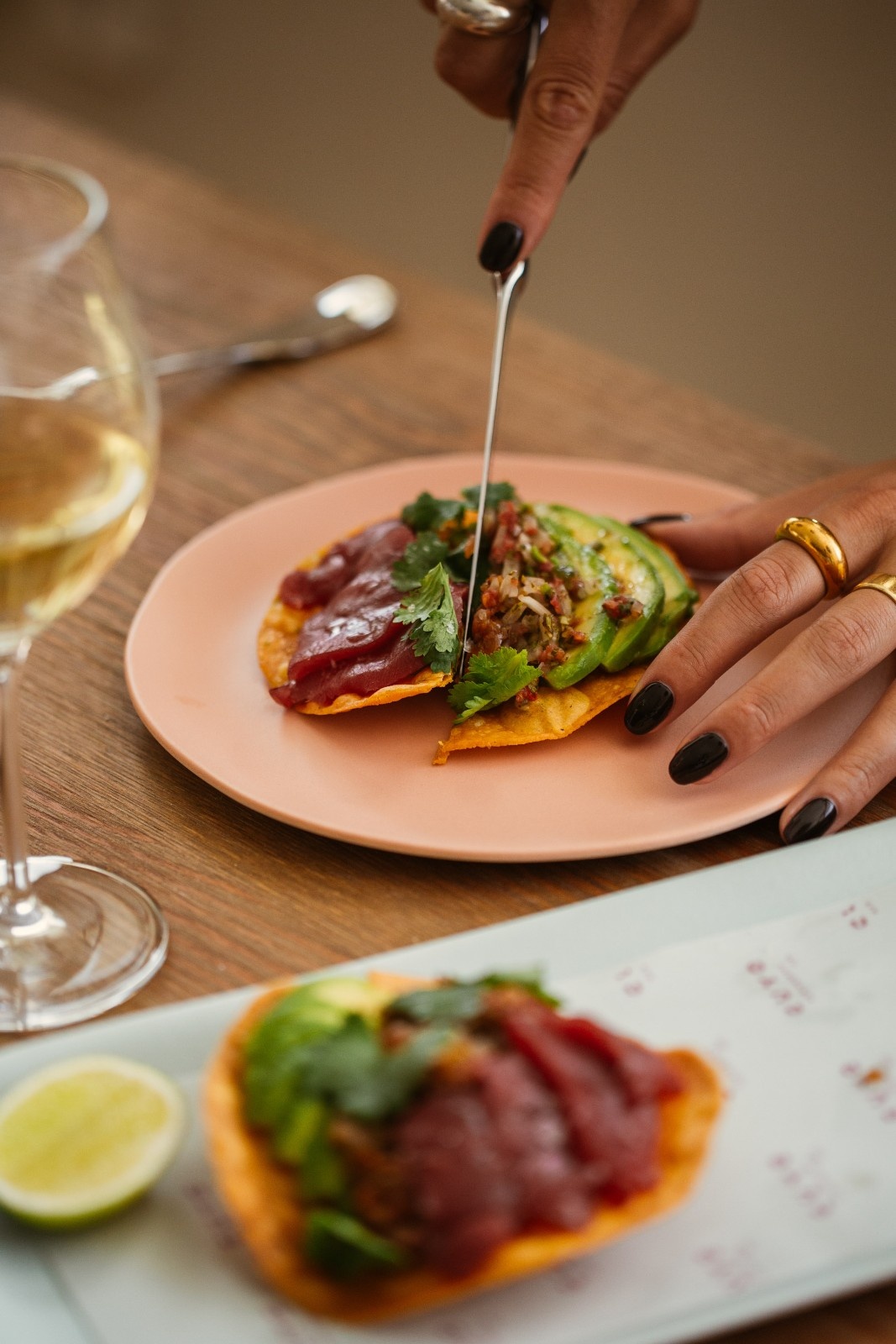 a taco on a plate with someone pouring a liquid over it