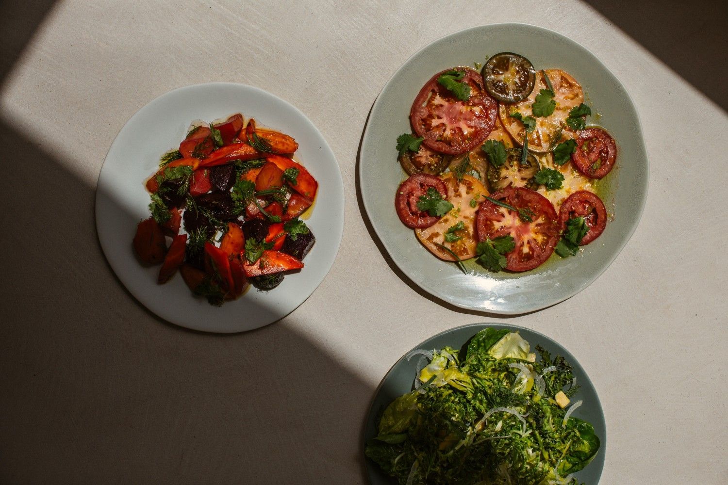 a couple of dishes of Cuyo on a table with shadow closing in
