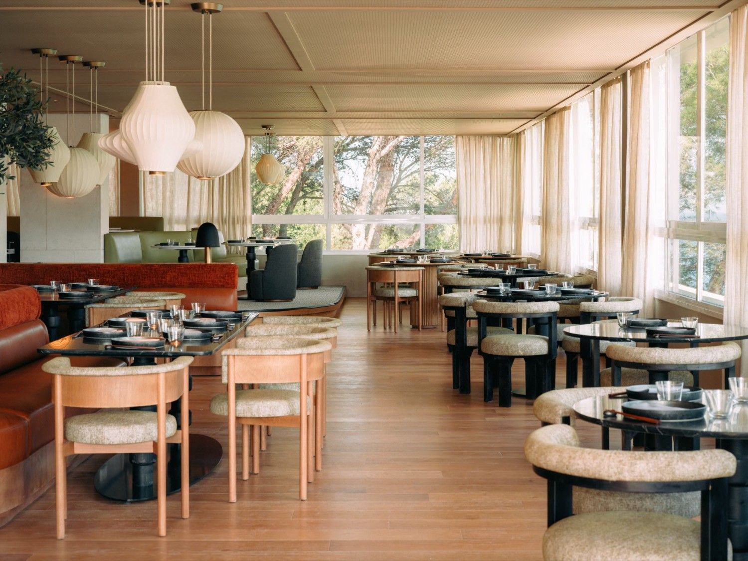 empty restaurant room with multiple tables with chairs around it