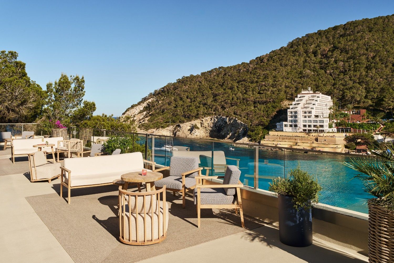 outside terrace showing with multiple seats and tables with a body of water next to it