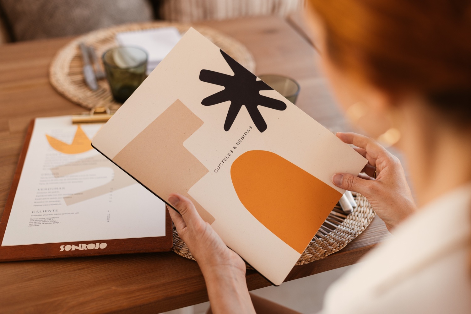 person holding the menu of the restaurant