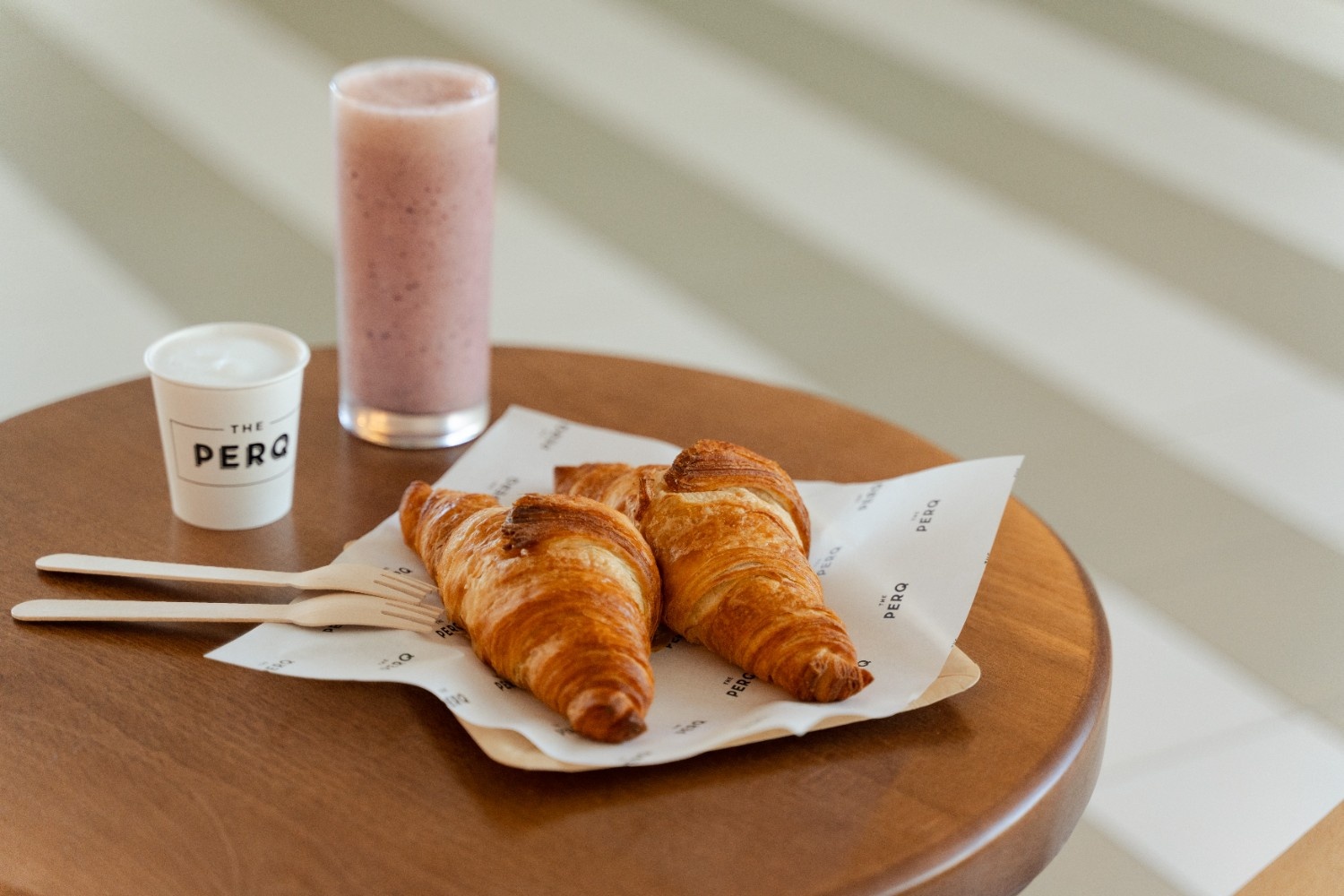 two croissants and a smoothie on a table