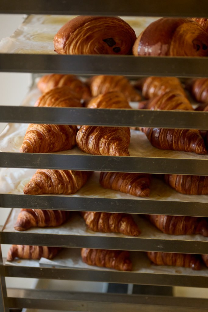 Image of a couple of trays with freshly baked croissant's on the trays