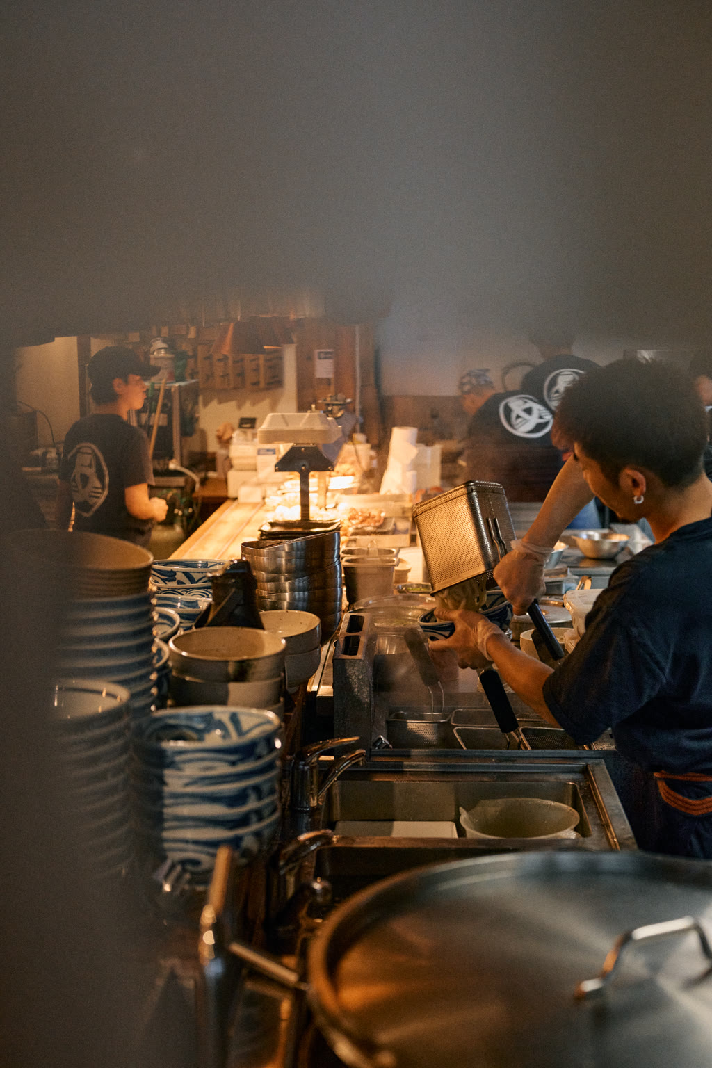 Image of restaurant kitchen, noodles being prepared