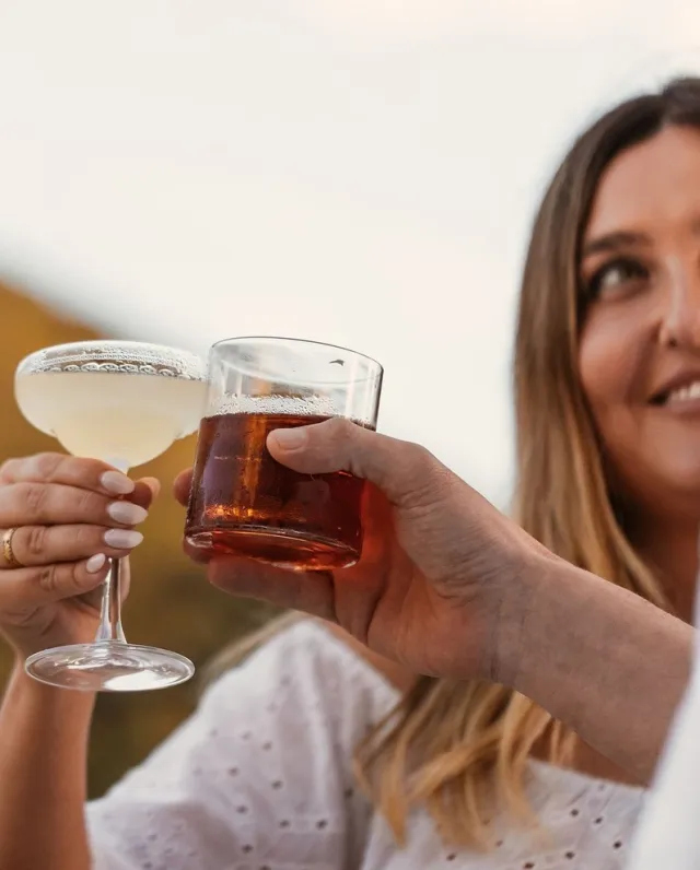 Two people enjoying their cocktails