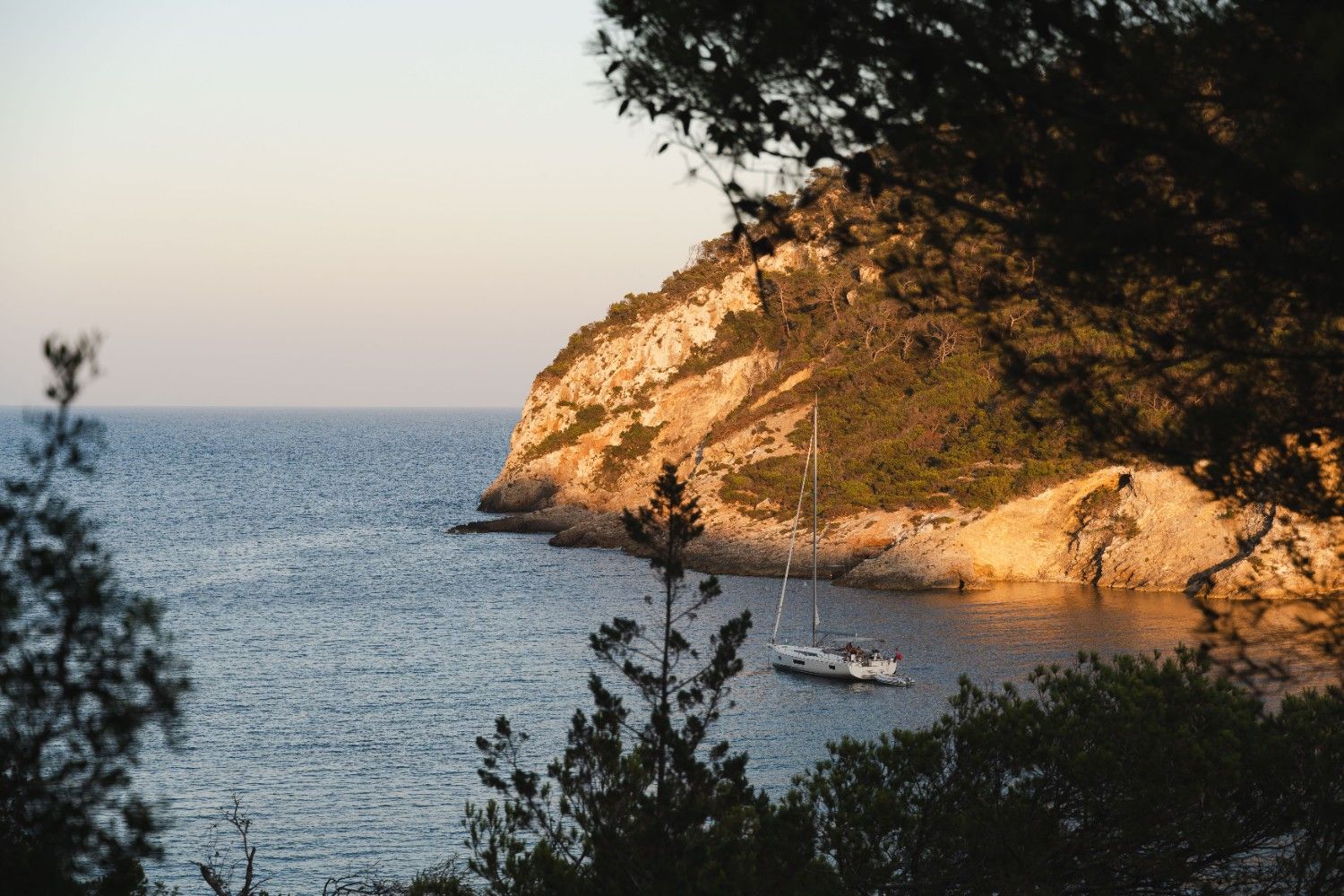 beautiful view higher up a cliff showing a body of water with a boat on it