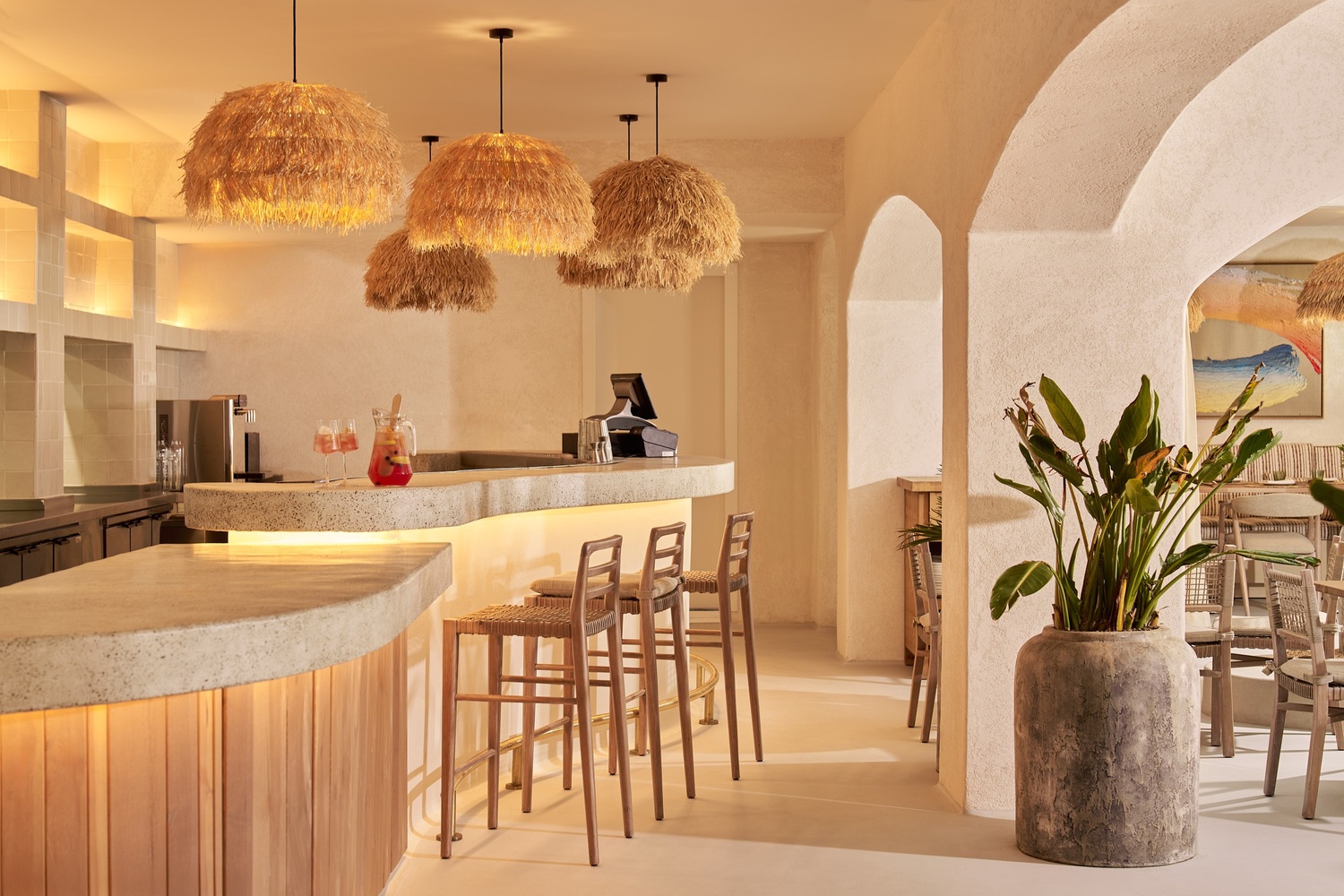 bar of a restaurant with a couple of high chairs behind it