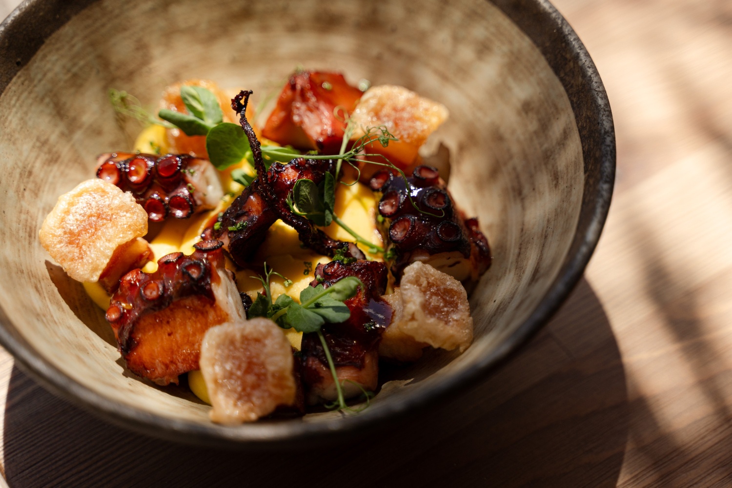 bowl of fresh food with pieces of octopus