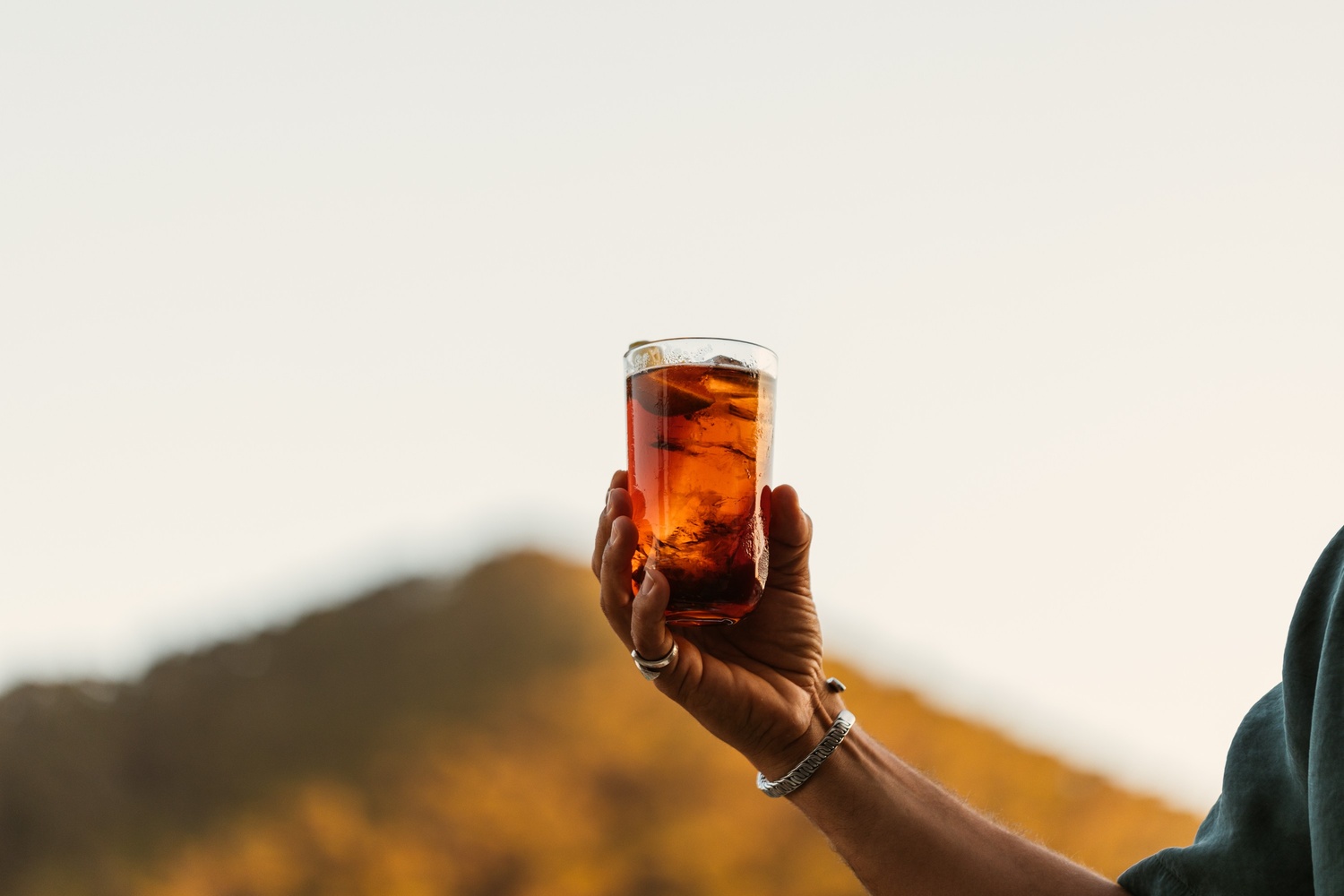 someone showing their drink and holding up