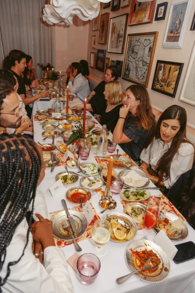 people enjoying food on a long table at Leydi, London City