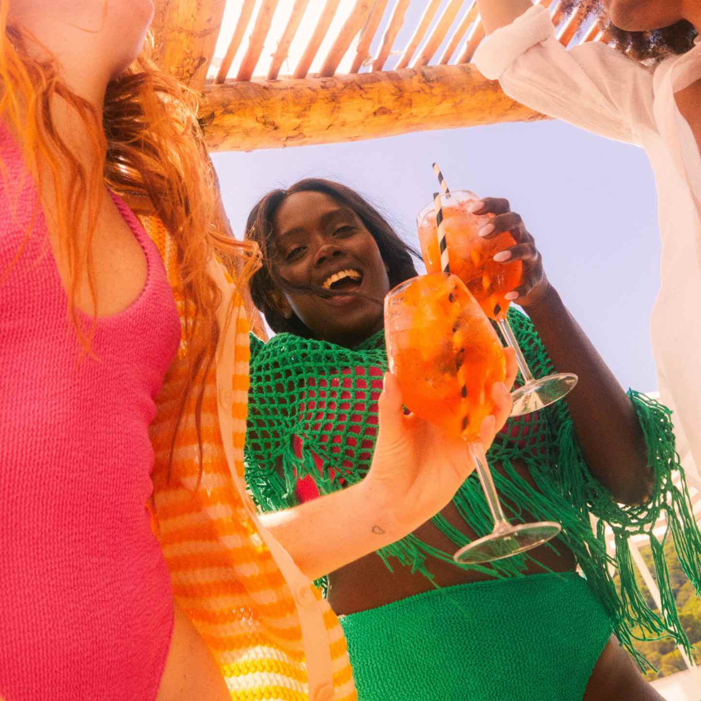 outdoor friends dancing and drinking together