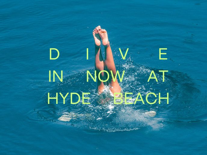 Feet sticking out of blue water with text that says 'DIVE IN NOW AT HYDE BEACH'