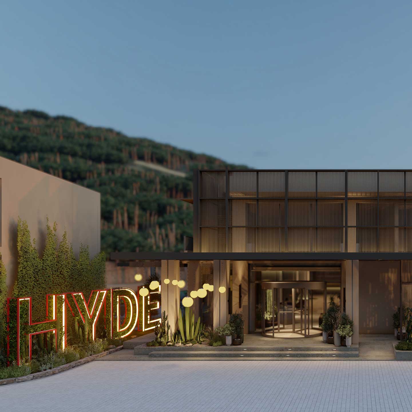 Entrance to the hotel at dusk, with a large HYDE sign on the left