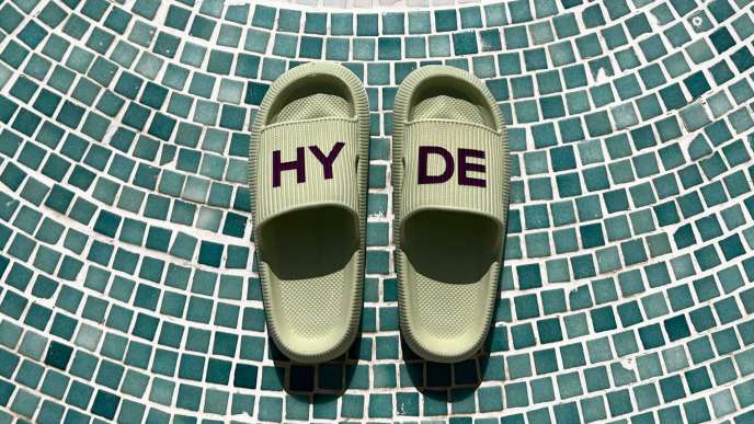 Green slides that say HYDE on them on blue tiles