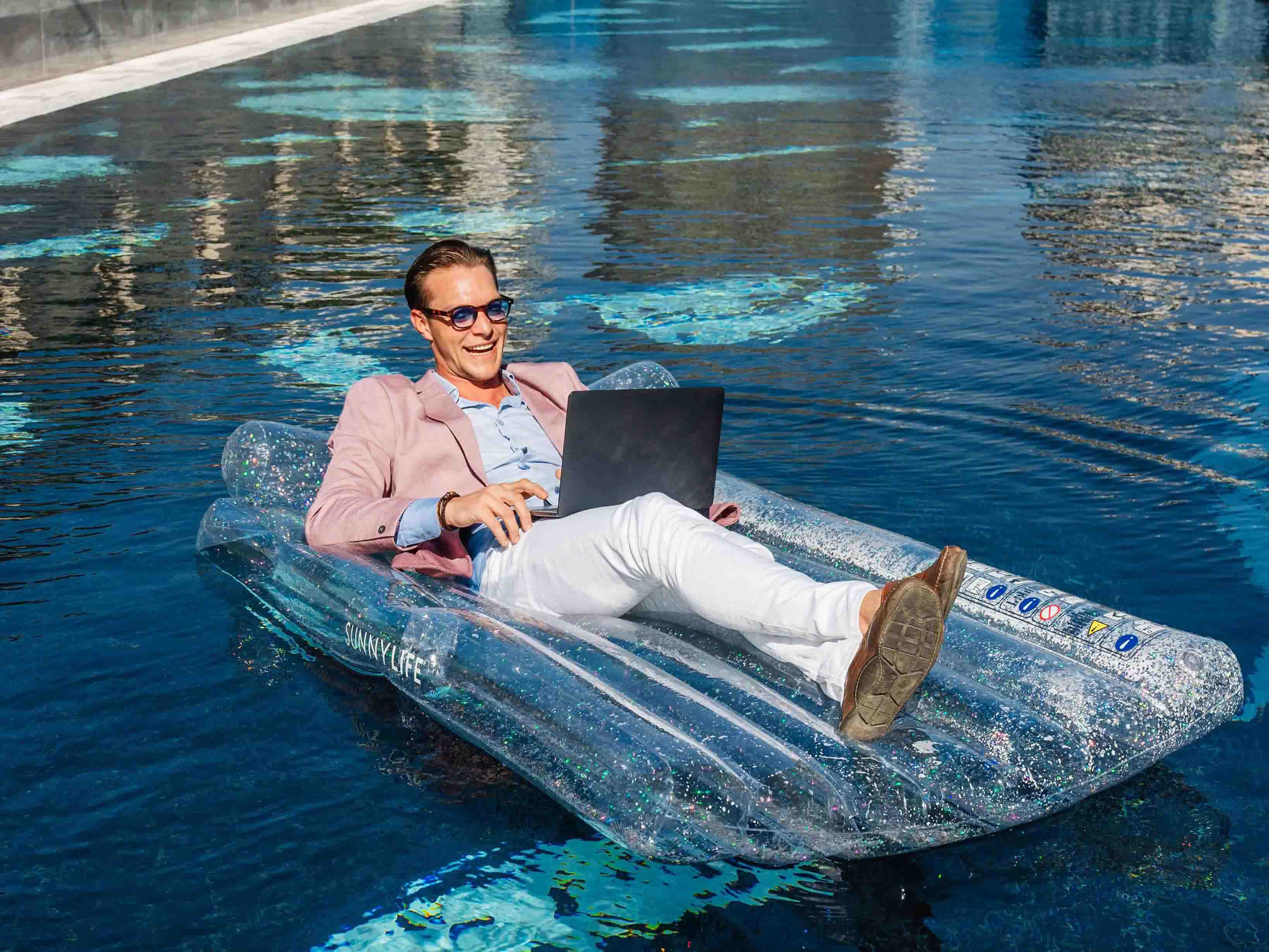 Hyde Dubai Man in Pool on Laptop