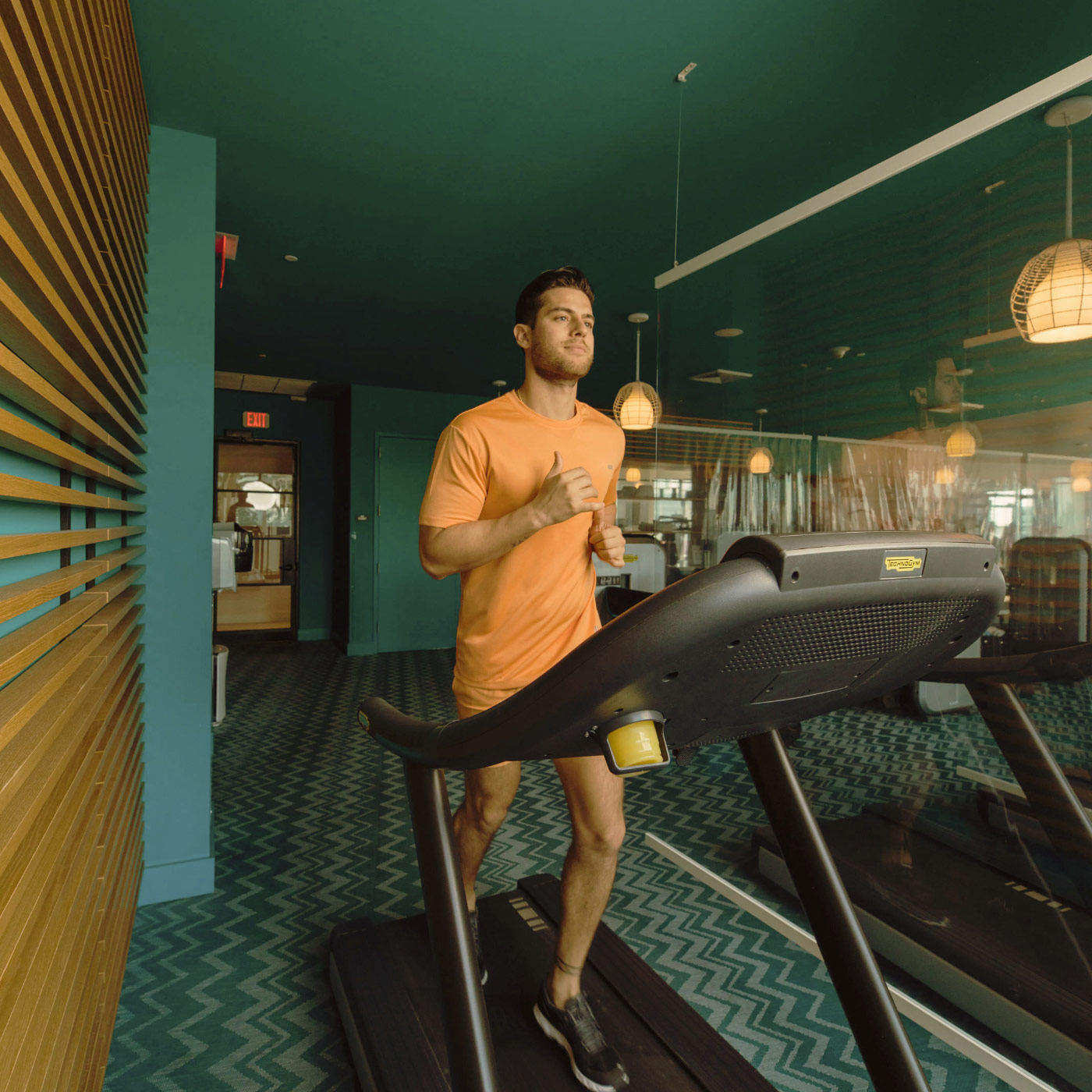 A man running on a treadmill at Hyde Midtown Miami Gym