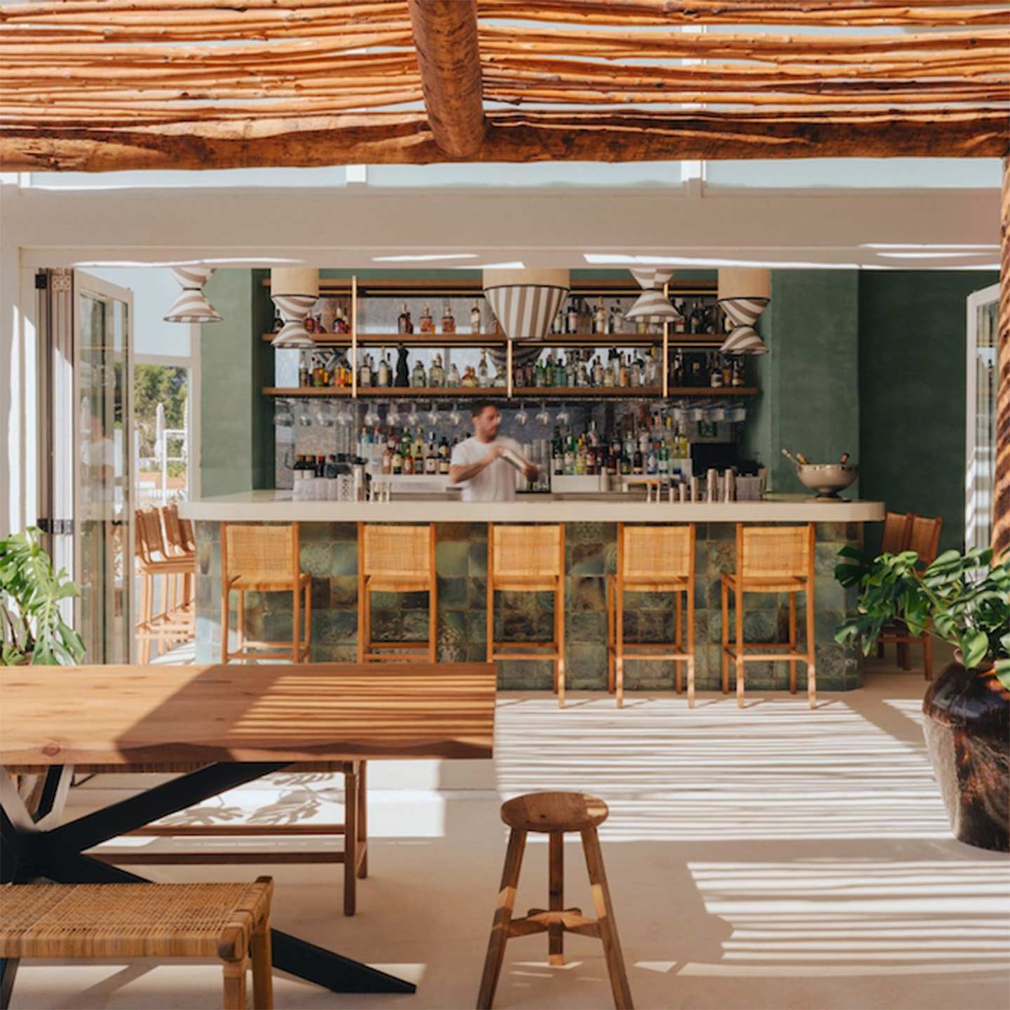 Outside bar with bartender making drinks.