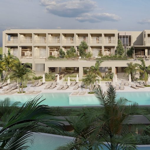 Large blue pool with chiase lounges, umbrellas, and beige building in the background with palms trees scattered throughout
