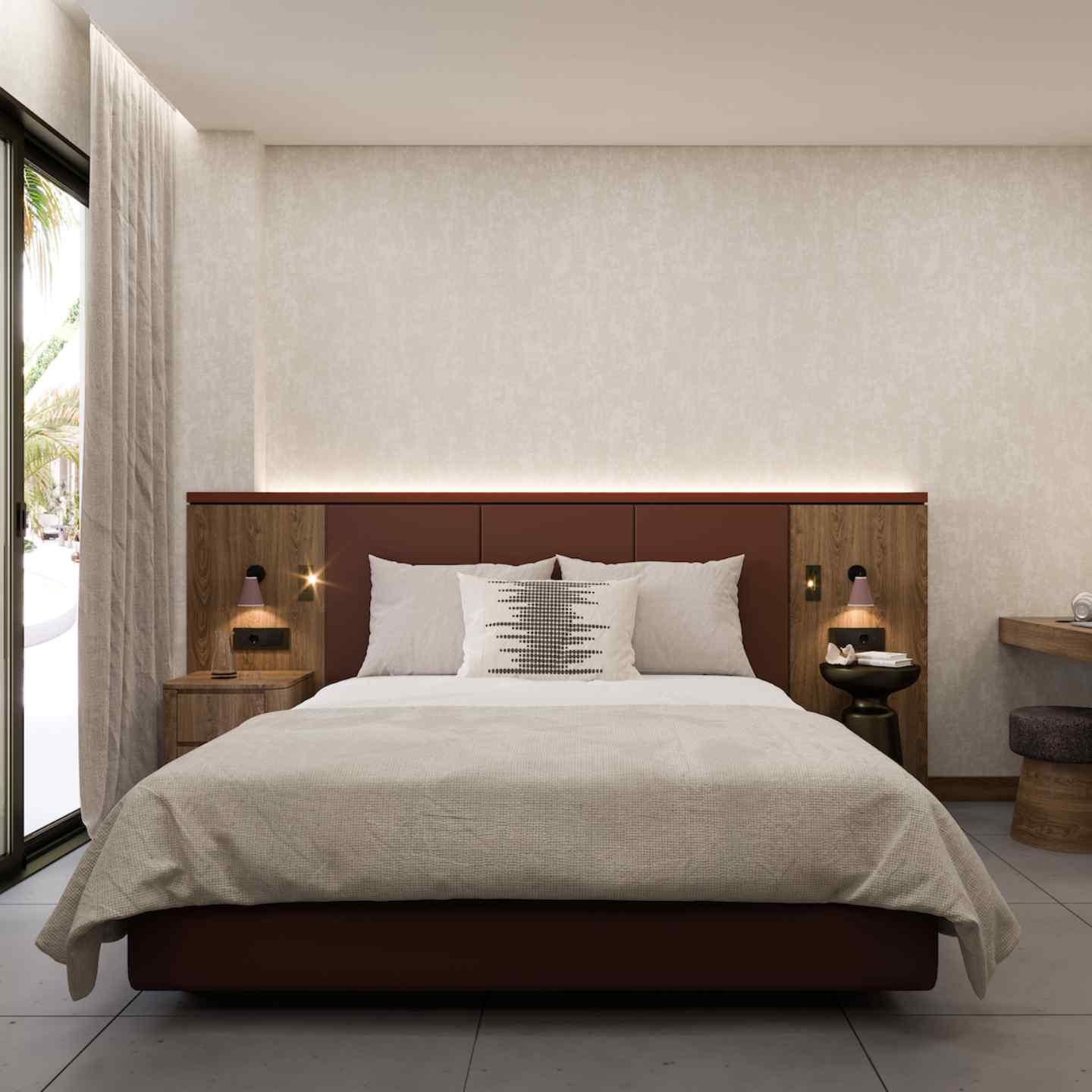 Large bed with wooden headboard and beige bedding with beige wall and curtains in the background