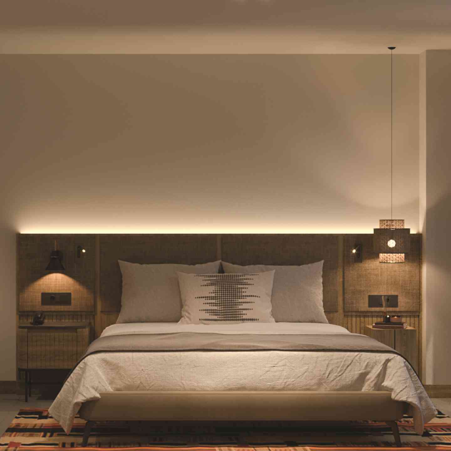 Large bed in beige bedding lit by soft lights with a large wooden headboard and beige wall