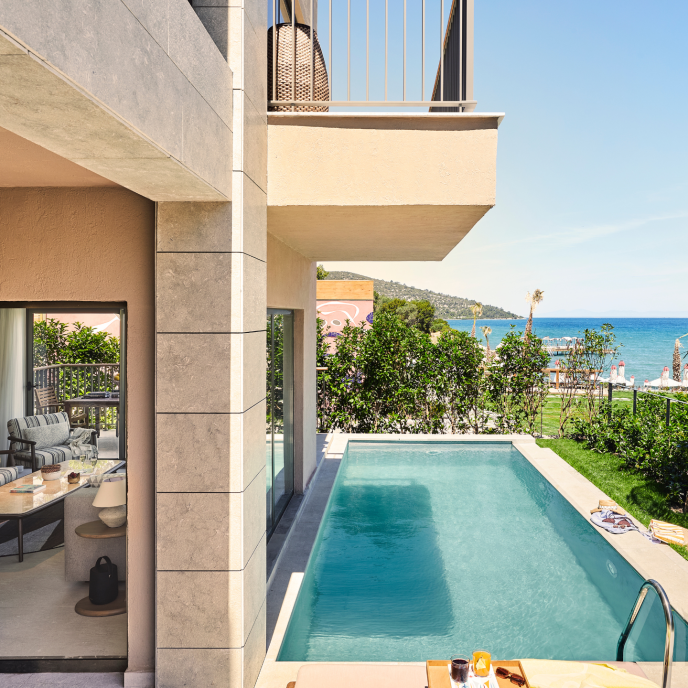 Image of a hotel with private pool and sea views with greenery and above a balcony