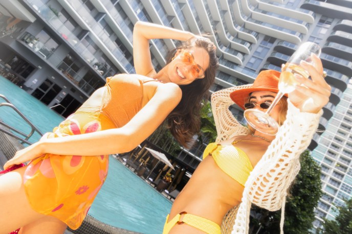 Two women dancing in the sun in front of Hyde Ibiza hotel