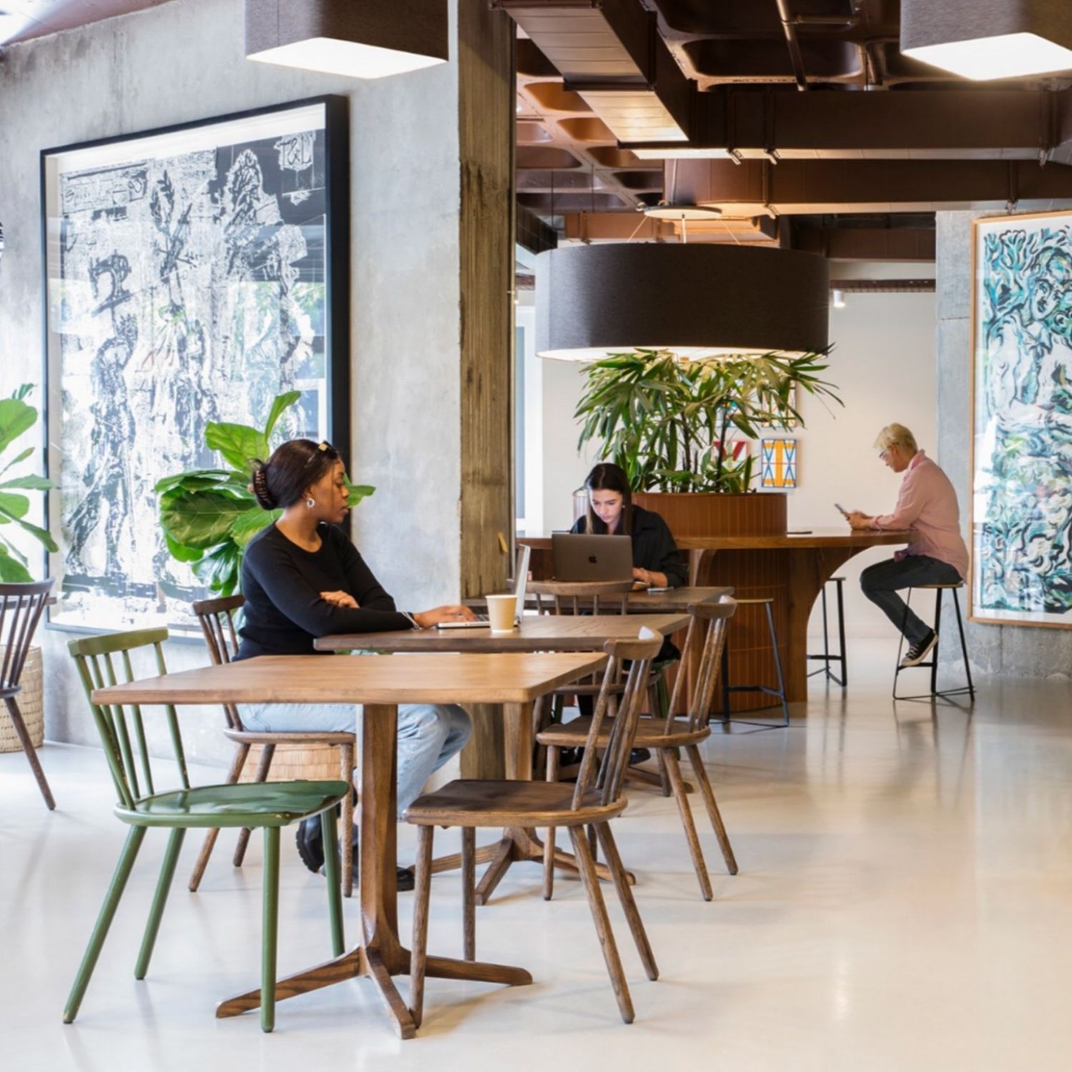 Hyde Johannesburg's open workspace, with oak wood tables and chairs.